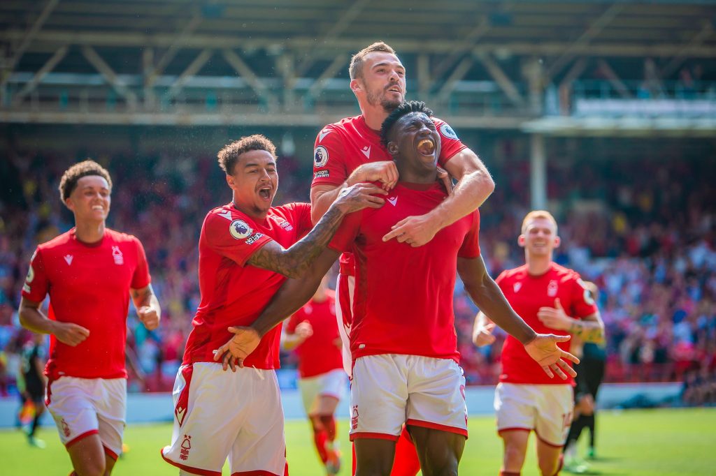  Nottingham Forest players Brennan Johnson, Sam Surridge, and Ryan Yates celebrate a goal during a Premier League match at the City Ground.